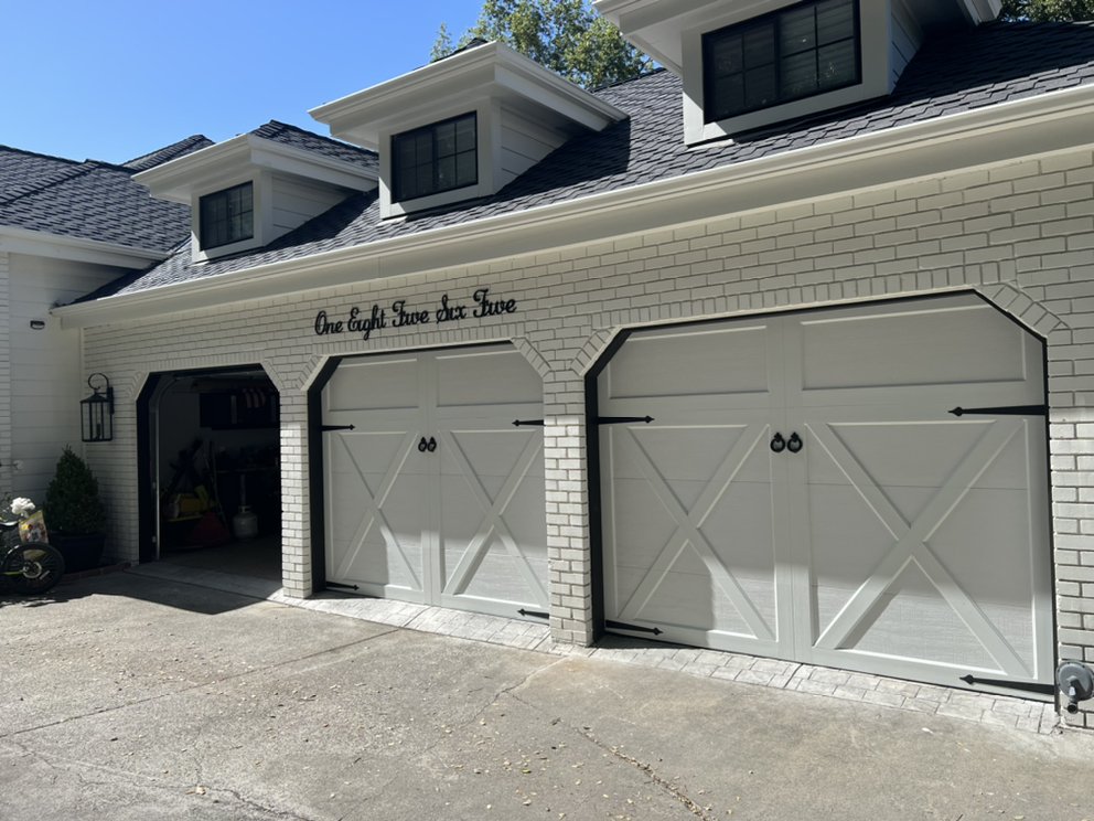 Gray carriage-style garage doors with cross-buck hardware